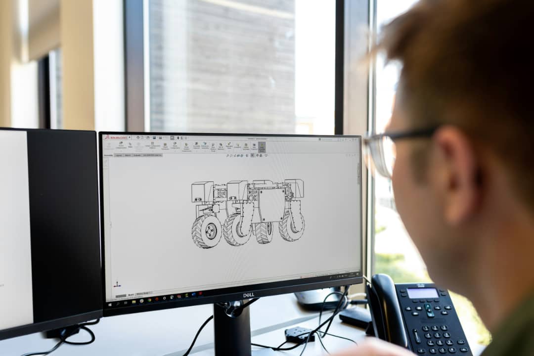 Engineer reviewing CAD technical drawing on a monitor